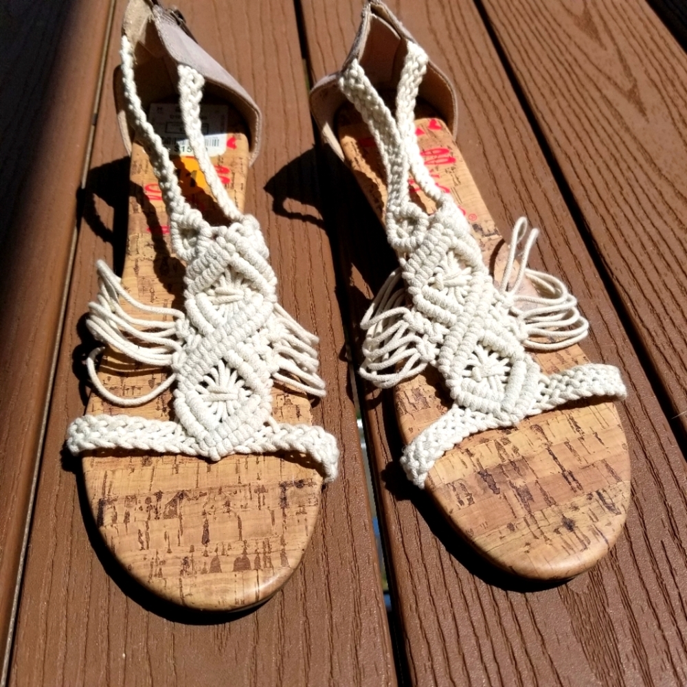 Size 11 Sandal with a white nylon design and cork sole.